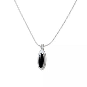 Geometric agate pendant necklace in brushed silver with black stone inlay.