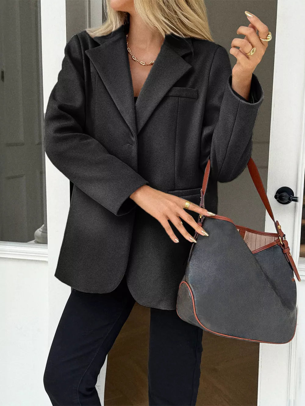 Chic black lapel blazer with button closure and pocket detail.