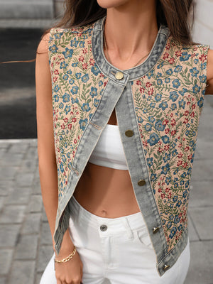 Embroidered floral denim vest with button front and cropped length.