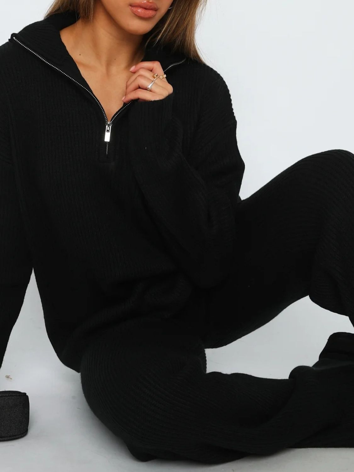 Black ribbed knit quarter-zip loungewear set with a relaxed fit.