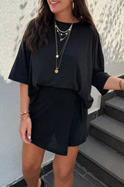 Black tie-wrap two-piece outfit set with a relaxed tee and asymmetric skirt.