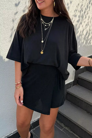 Black tie-wrap two-piece outfit set with a relaxed tee and asymmetric skirt.