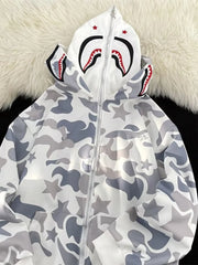 Off-white camo print zip-up hoodie with shark graphic on hood and star details.