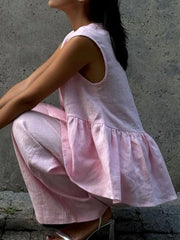 Blush pink sleeveless peplum top and wide-leg pants set in cotton.