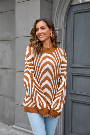 Caramel and white zebra stripe knit pullover sweater with voluminous sleeves.