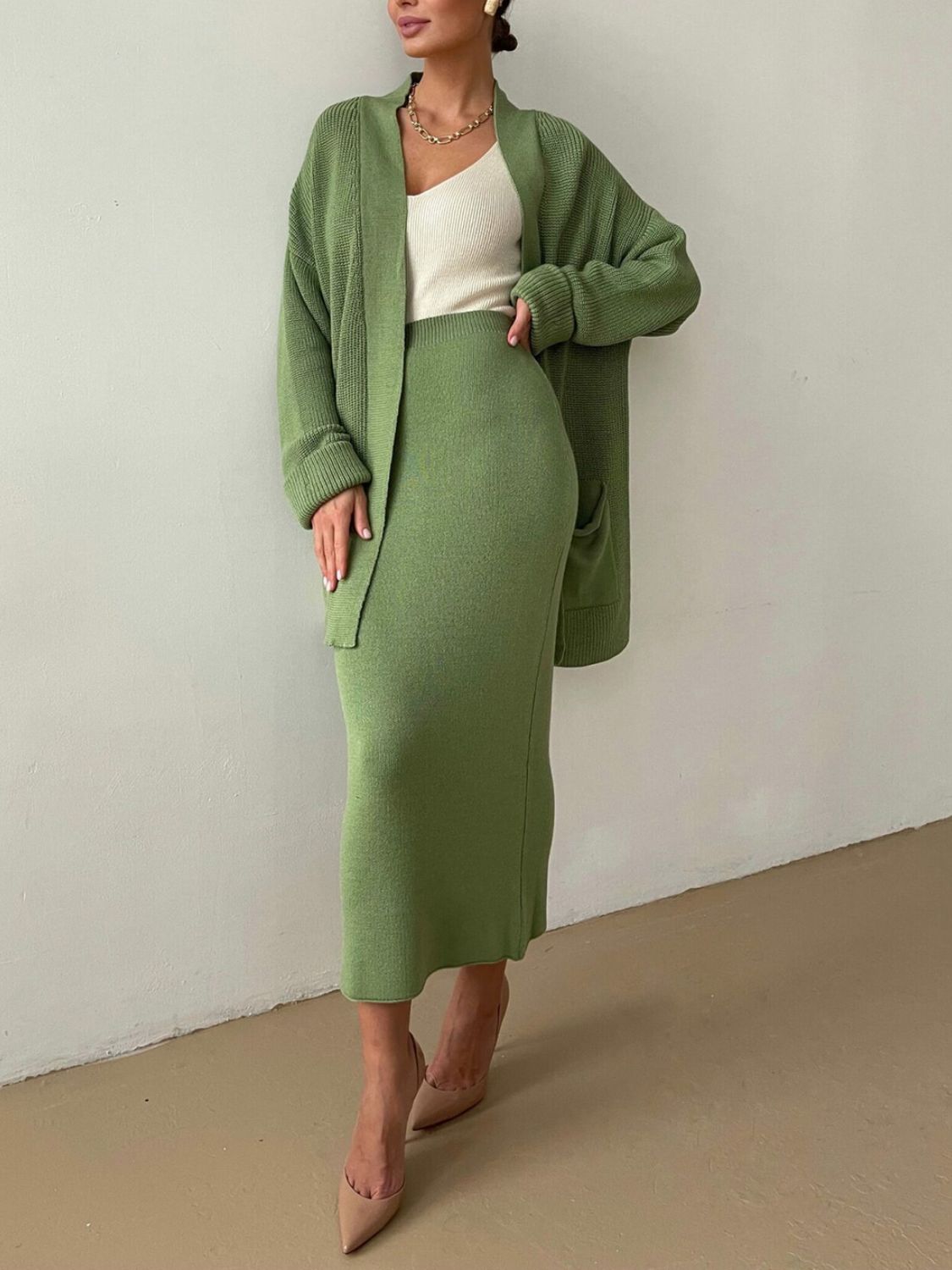 Ribbed knit co-ord set in Gum Leaf green, featuring a midi skirt and open cardigan.