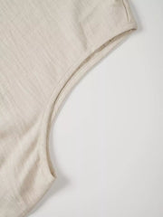 Textured beige sleeveless top with V-notch detail and clean seams