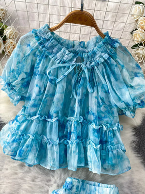 Sky blue floral ruffle bikini top with bow detail and puff sleeves.