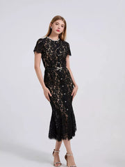 Black floral lace mermaid dress with short sleeves, pearl neckline, and embellished belt.