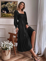 Black smocked midi dress with puff sleeves, square neckline, and tiered hem.