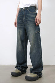 Baggy dark navy denim jeans with knee slits and distressed details.