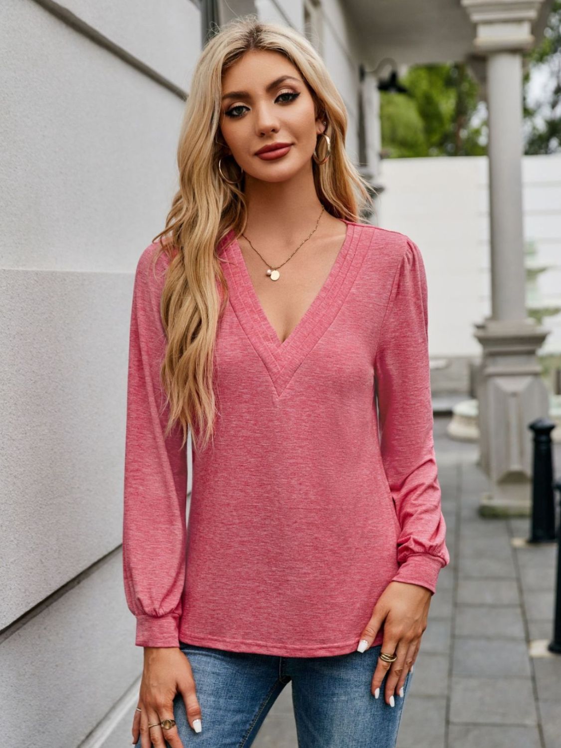 Plunge neckline gathered sleeve top in strawberry pink, with a textured neckline detail.
