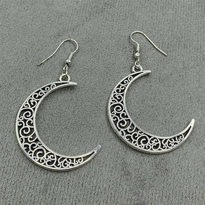 Filigree crescent drop earrings in Moon color with intricate scrollwork detail.