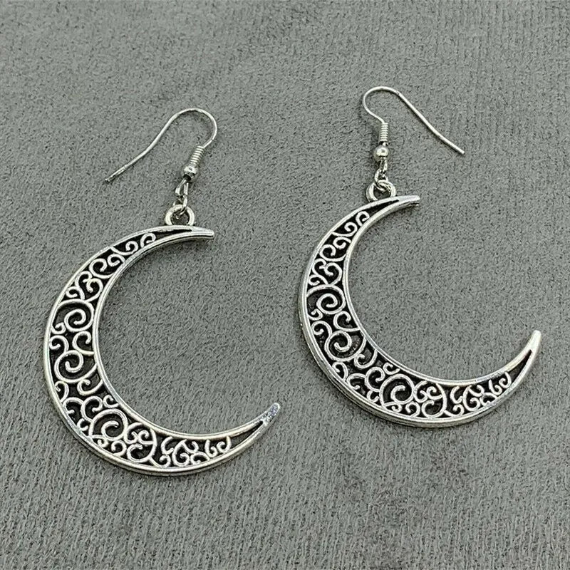 Filigree crescent drop earrings in Moon color with intricate scrollwork detail.