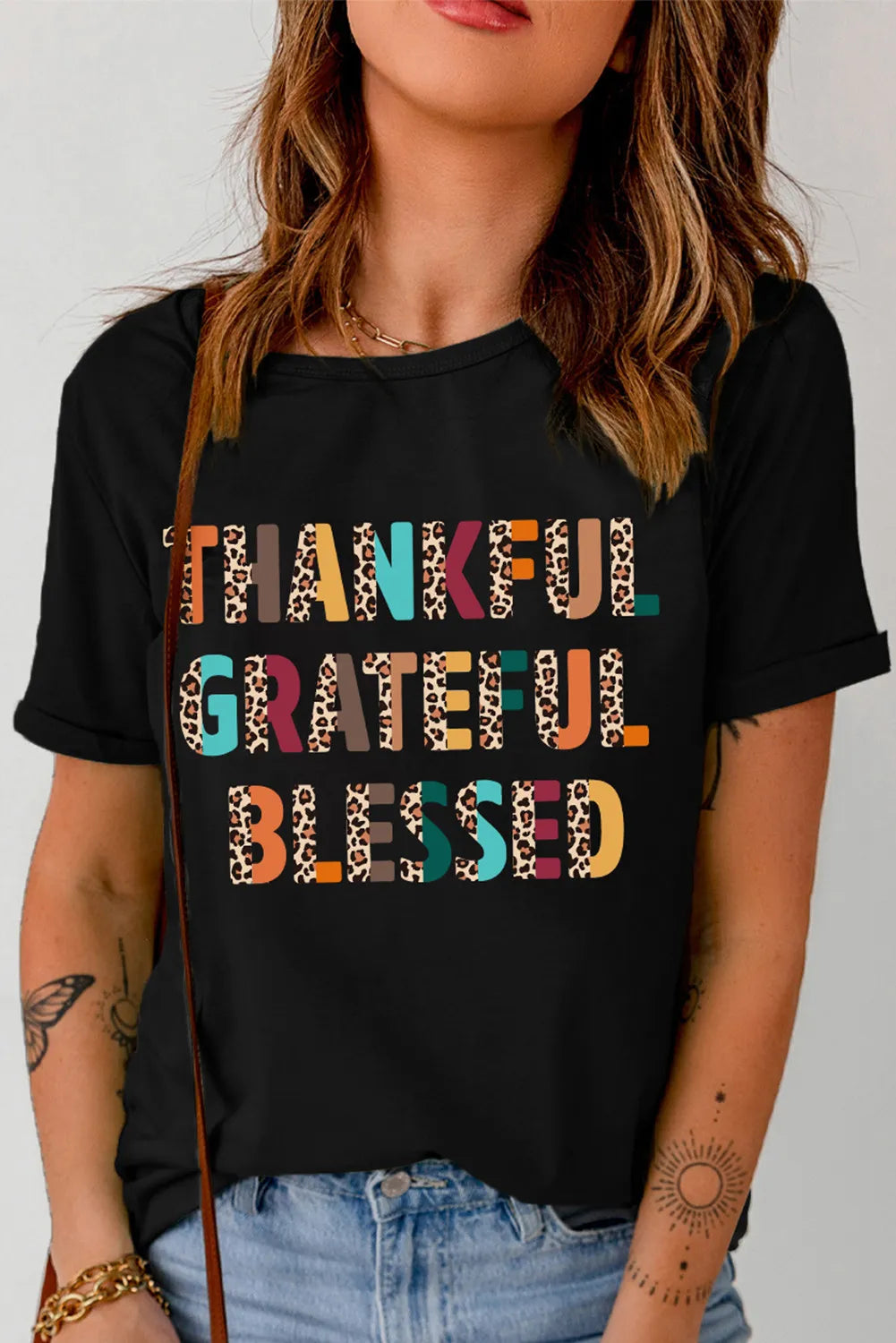 Black graphic tee with leopard print "Thankful Grateful Blessed" text