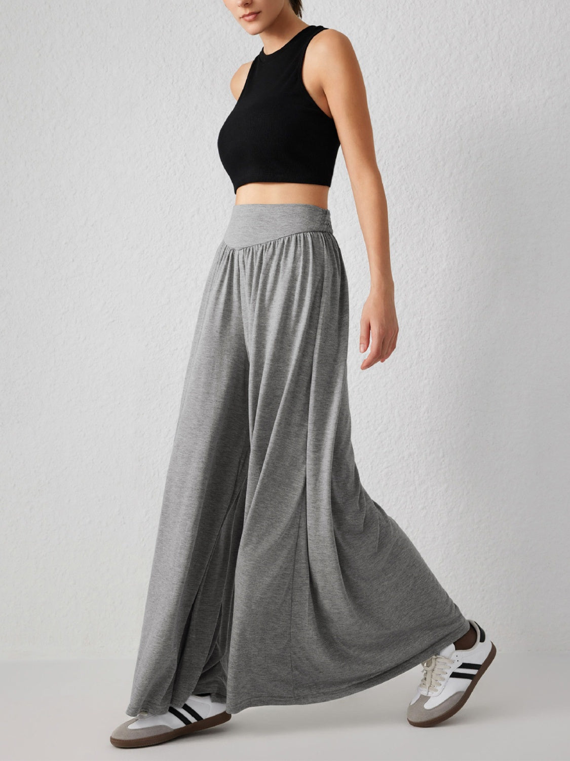 Gray jersey wide-leg trousers with a drape-front and elastic waistband.