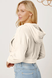 Waffle knit cropped zip hoodie in ivory with a kangaroo pocket and drawstring hood.