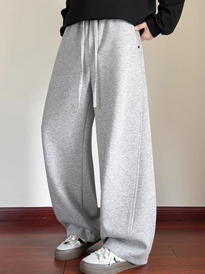 Men's gray drawstring wide-leg sweatpants with a relaxed fit.