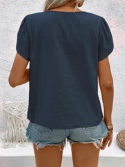 Indigo linen puff sleeve blouse with a V-neck, shown from the back.