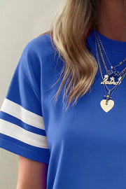 Blue crew neck t-shirt with white varsity stripes on the sleeves.