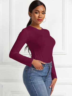 Burgundy ribbed jersey bodysuit with long sleeves and crew neck, styled with jeans.