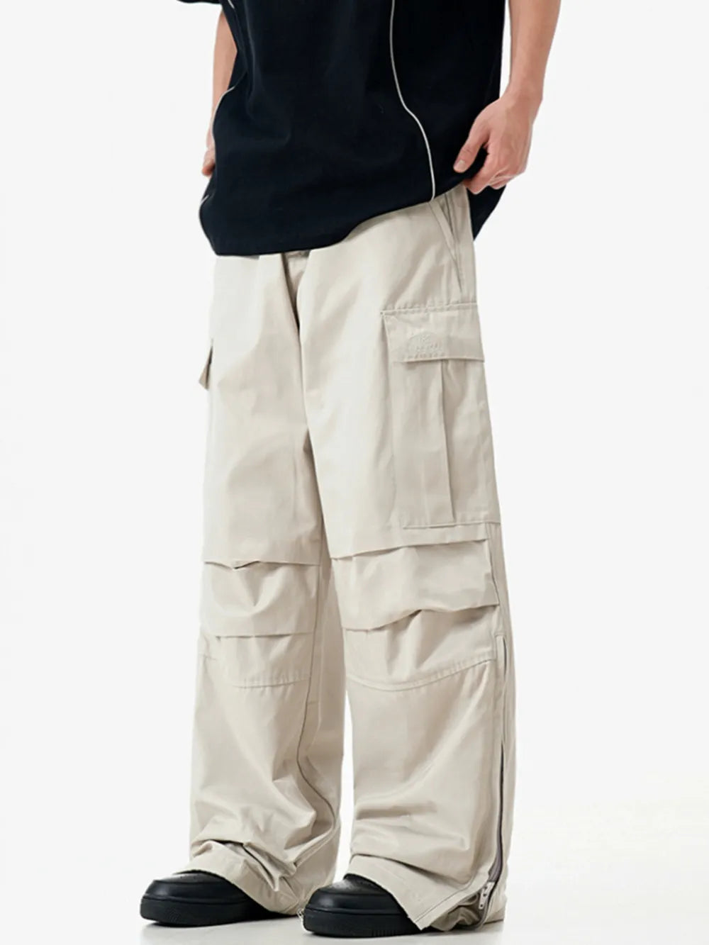 Apricot cargo sweatpants with multiple pockets and zippered ankles.