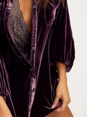 Deep purple velvet oversized shirt with button front and puff sleeves, styled with lace bralette.