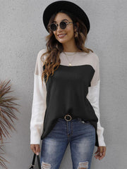 Colorblock crewneck knit sweater in black, cream, and white acrylic with side slits.