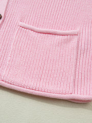 Pink acrylic knit sweater vest with button front and patch pocket detail