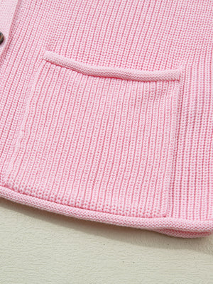Pink acrylic knit sweater vest with button front and patch pocket detail
