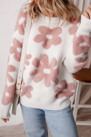 Textured floral knit pullover sweater in white with pink blooms, crew neck, long sleeves.