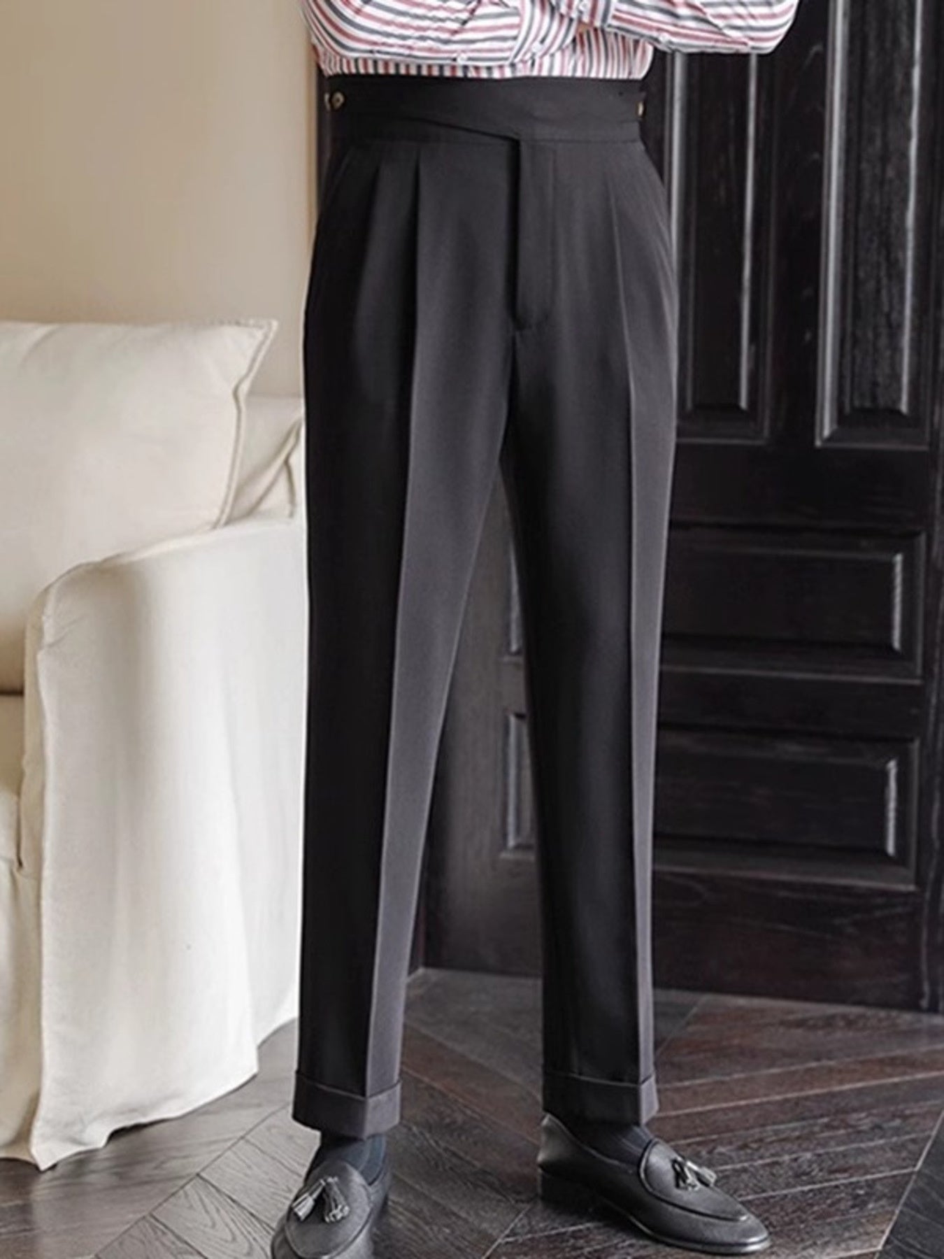 Black pleated wide-leg dress pants with cuffed hem and a high waist.