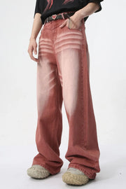 Sunset dip-dye wide leg jeans in rust with a faded, distressed look.