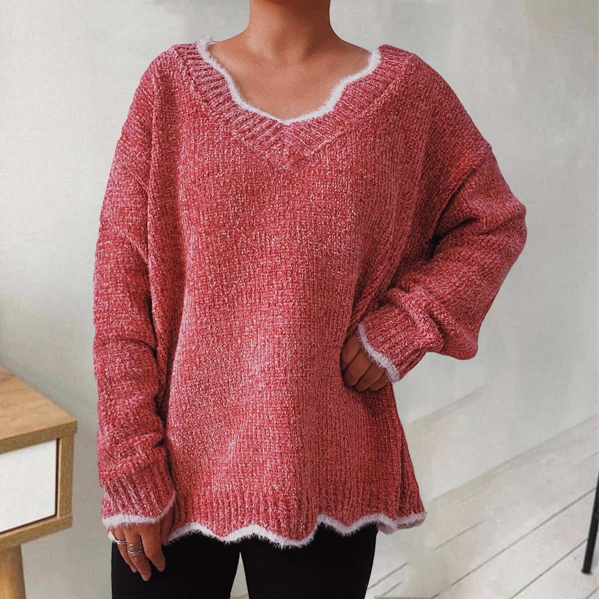 Coral luxe knit sweater with scalloped trim and V-neck.