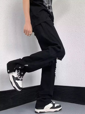 Black distressed loose-fit jeans with snap detail and adjustable hem