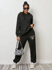 Black graphic hoodie and jogger set with "ENTHUSIASTIC 1987 REMAIN" print