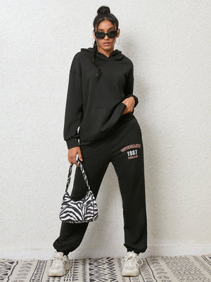 Black graphic hoodie and jogger set with "ENTHUSIASTIC 1987 REMAIN" print