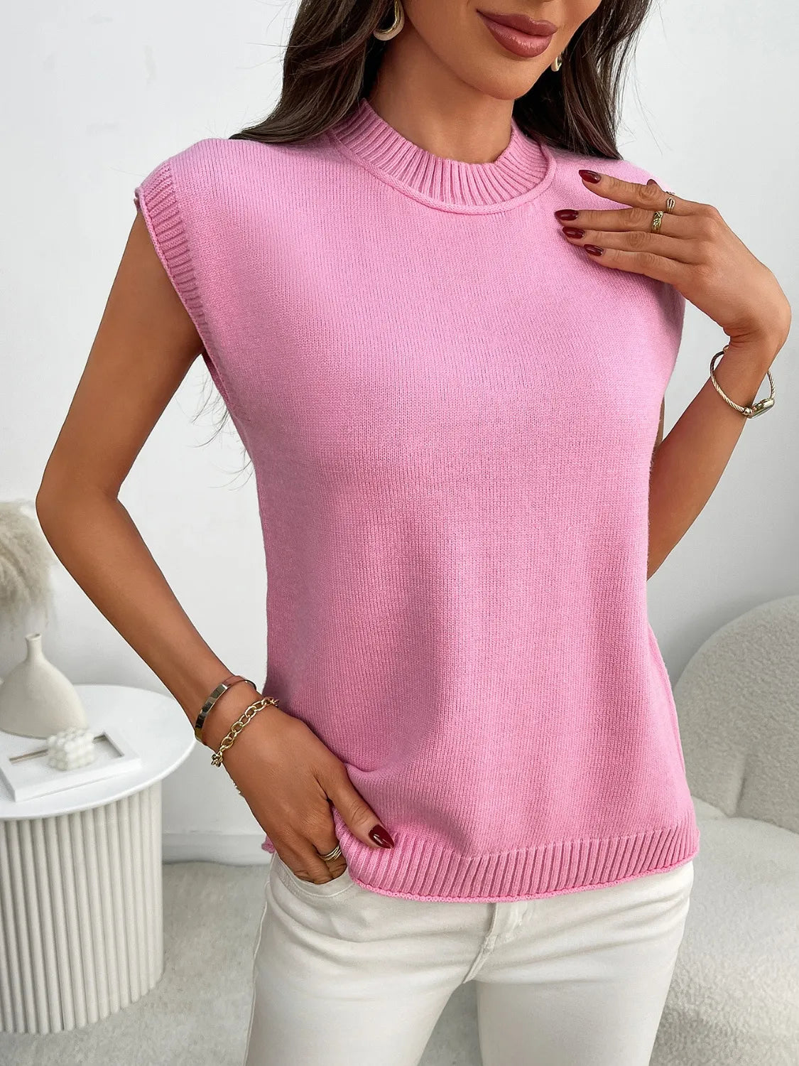 Pink ribbed knit sleeveless mock neck top with a casual fit.
