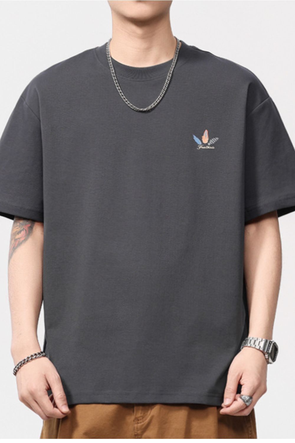 Men's dark gray cotton blend crew neck t-shirt with a small feather print detail.