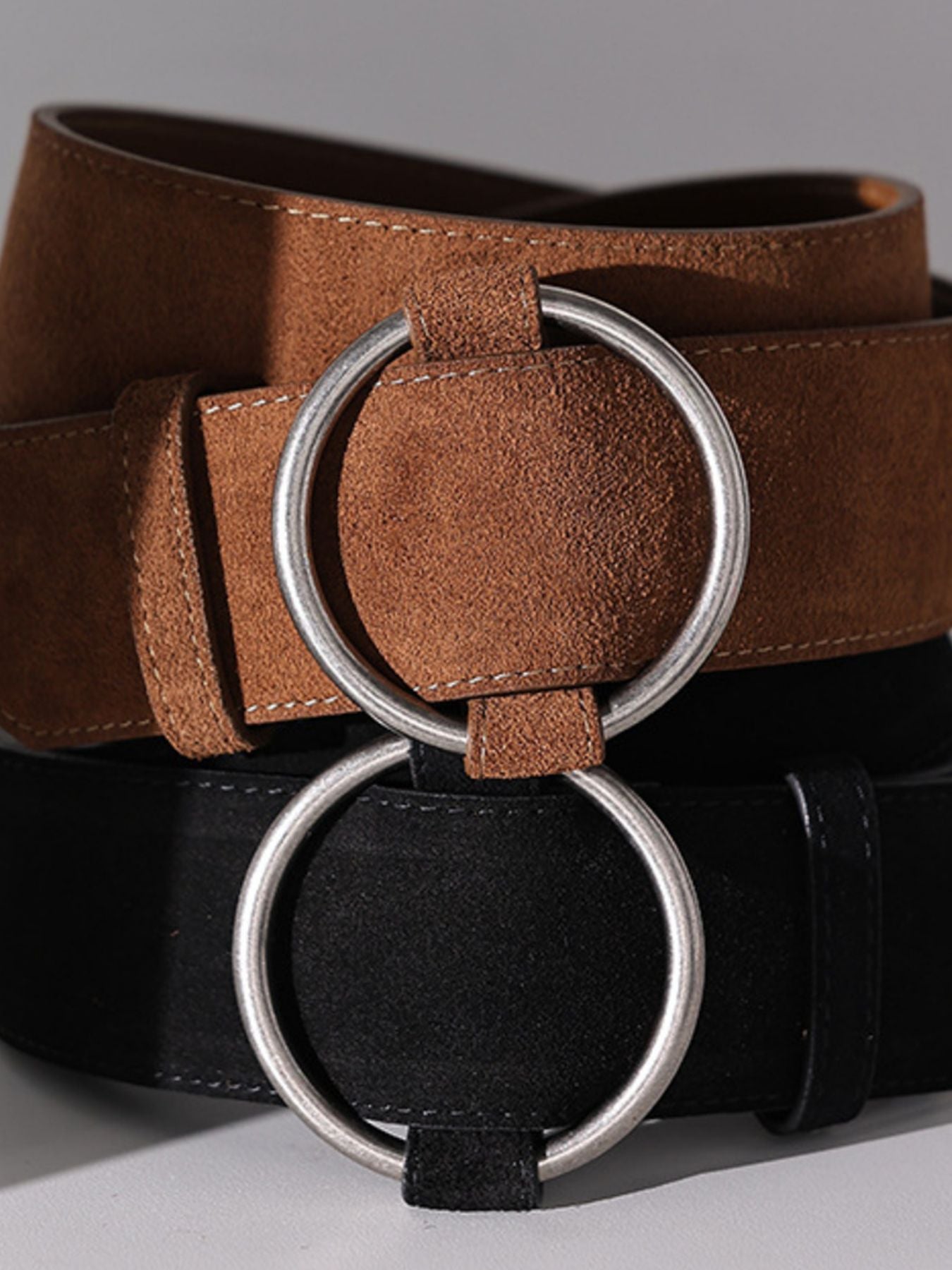 Brown and black cowhide leather belts with silver ring buckles
