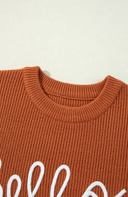 Terracotta knit sweater with white "Hello Pumpkin" script detail and crew neck.