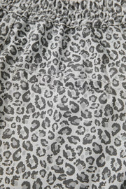 Denim shorts with a grey leopard print and elastic waistband.