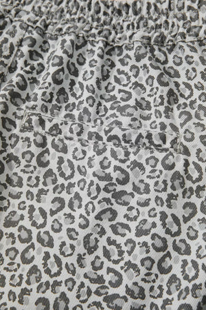 Denim shorts with a grey leopard print and elastic waistband.