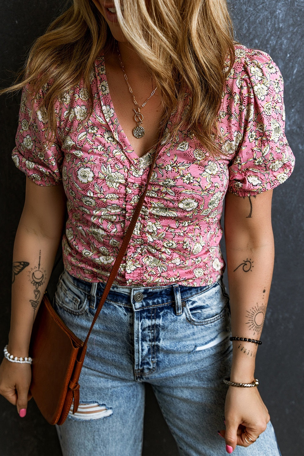 Floral ruched bodice puff sleeve top with a v-neckline and short sleeves.