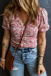 Floral ruched bodice puff sleeve top with a v-neckline and short sleeves.