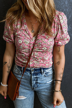 Floral ruched bodice puff sleeve top with a v-neckline and short sleeves.