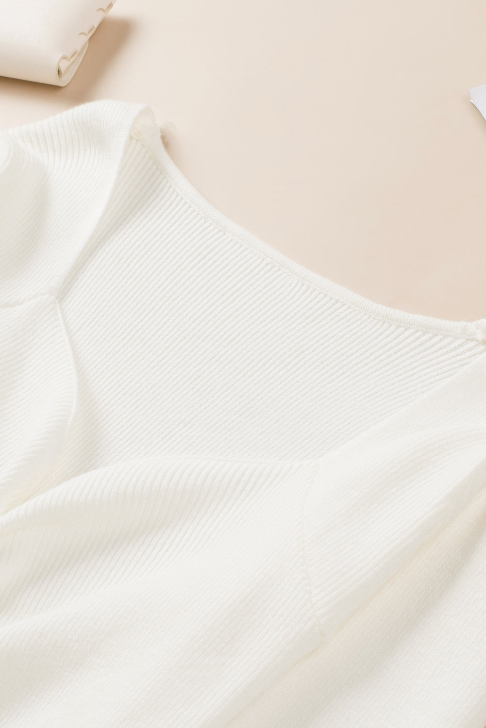 Ivory ribbed knit sweater with ruched front detail