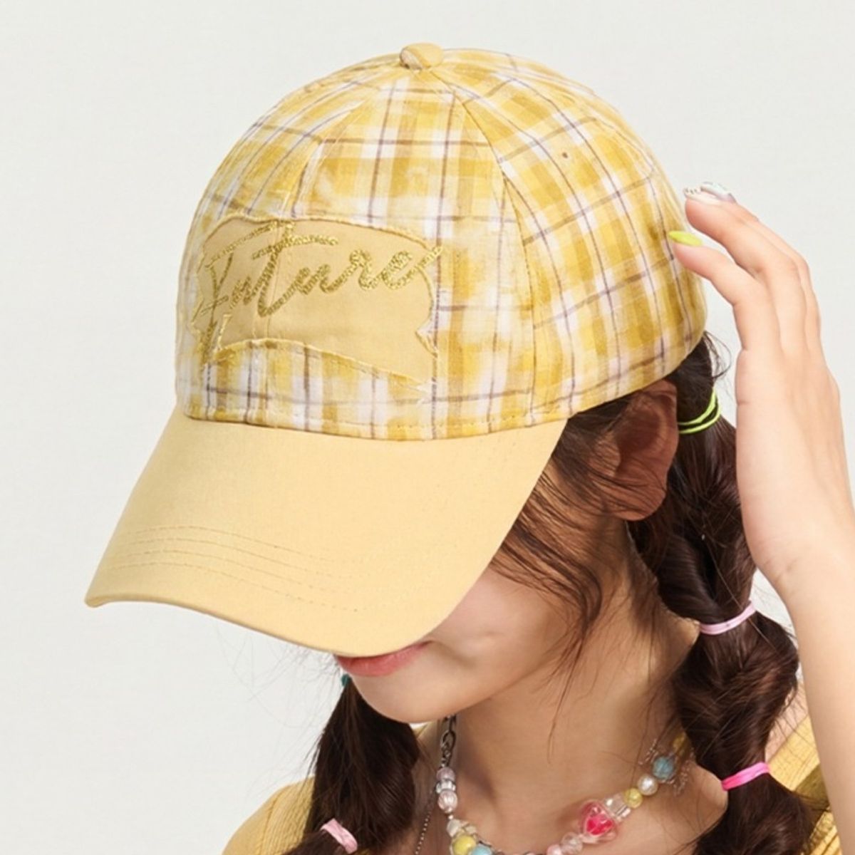 Yellow plaid baseball cap with embroidered detail and solid brim