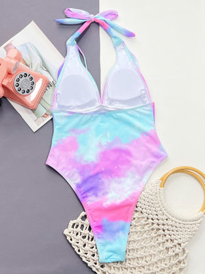 Multicolor tie-dye plunge halter one-piece swimsuit with padded cups and adjustable tie back.