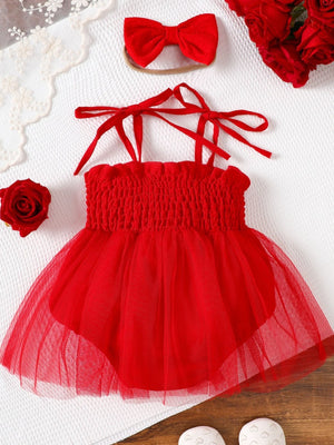 Red smocked bodysuit dress with tulle skirt and matching bow headband.
